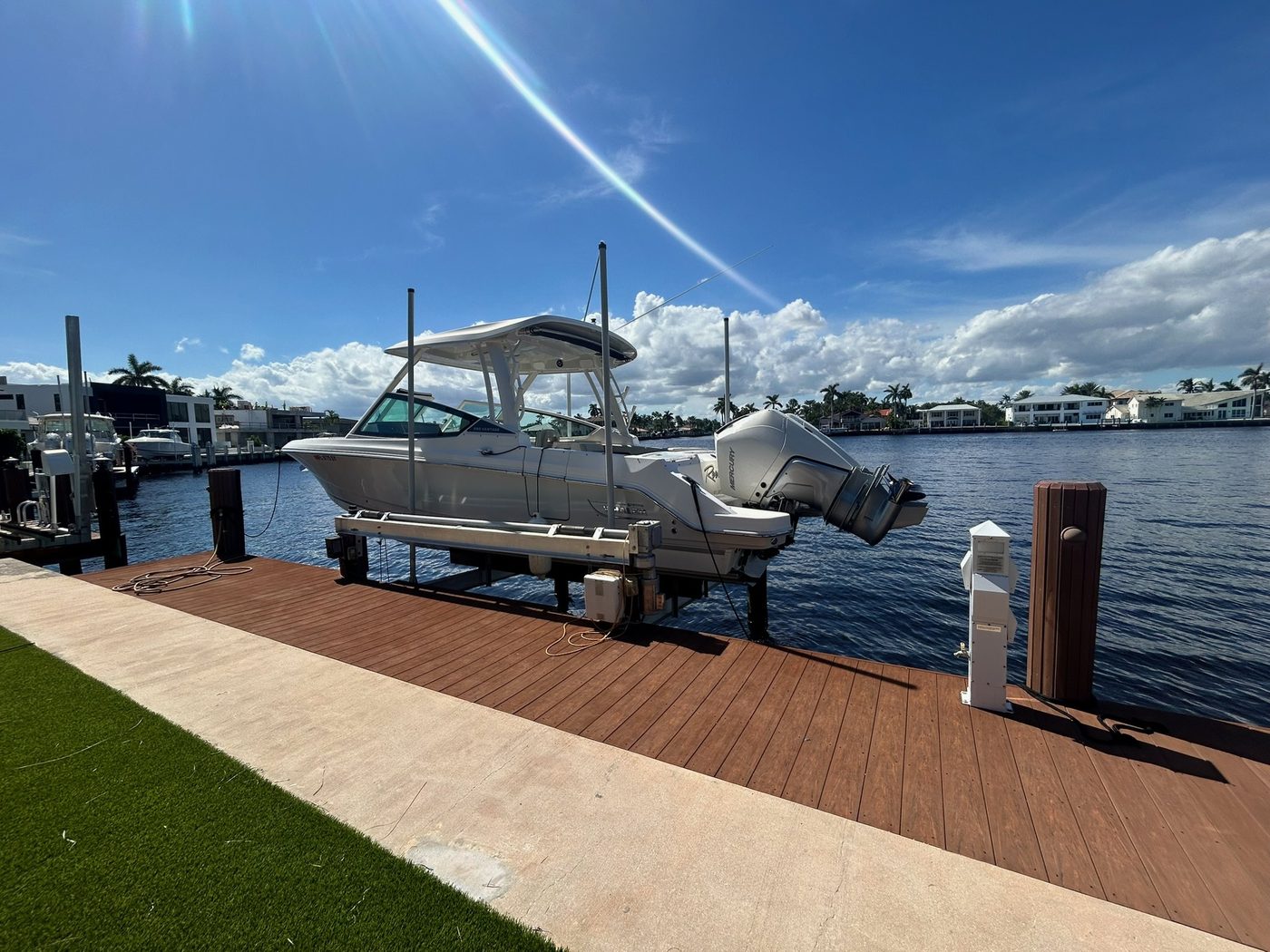Dual-console boat on lift at a South Florida residential dock